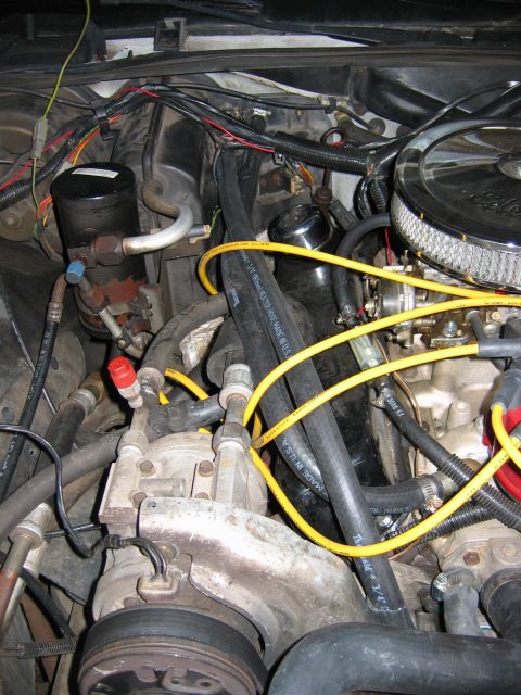 1985 Ford LTD Crown Victoria - Close-up view of an engine bay, showing various hoses, wiring, and engine components.