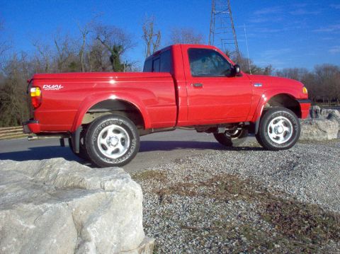 2001 Mazda B3000 - Side view of a red 2001 Mazda B3000 pickup truck parked outdoors.
