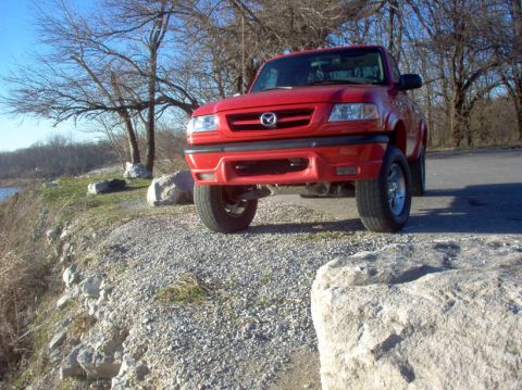 2001 Mazda B3000 - A red 2001 Mazda B3000 pickup truck is parked outdoors on a sunny day.