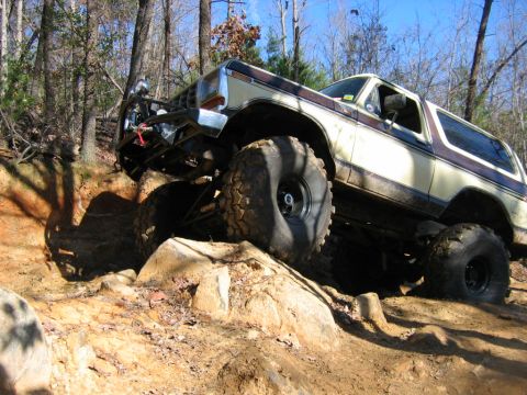 1992 Ford Mustang - A lifted Ford Bronco navigates a rocky trail, demonstrating its off-road capabilities.