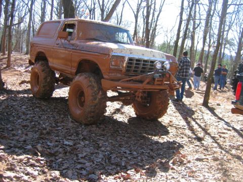 1992 Ford Mustang - This heavily mud-caked SUV is equipped for off-road adventures in a wooded area.