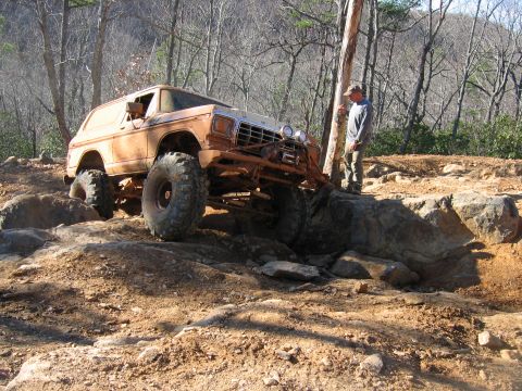 1992 Ford Mustang - An off-road vehicle navigates a challenging rocky path.