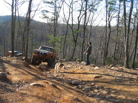 1992 Ford Mustang - Off-roading adventure on a challenging rocky trail with multiple vehicles.