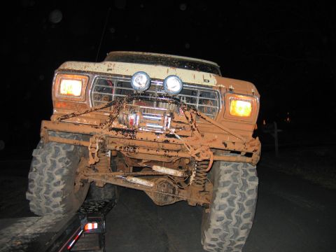 1992 Ford Mustang - This heavily mud-covered truck is shown from the front, equipped with a winch and auxiliary lights.