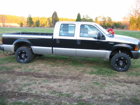 1992 Ford Mustang - A two-tone Ford F-250 Super Duty truck is viewed from the side in an outdoor setting.
