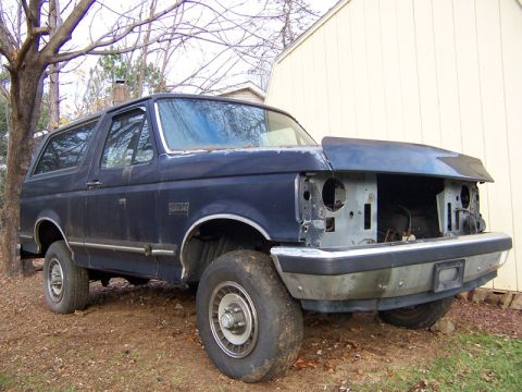 1987 Ford Bronco - This 1987 Ford Bronco is missing its front end components and appears to be in a state of disrepair.