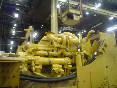 1966 International School Bus - Close-up of a large yellow diesel engine, likely for heavy machinery, with visible turbocharger and plumbing.