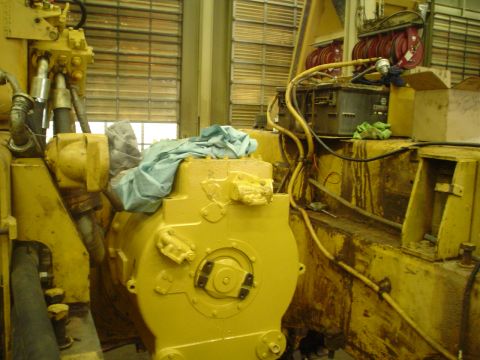 1966 International School Bus - A close-up view of a yellow industrial machine part, possibly undergoing maintenance or repair.