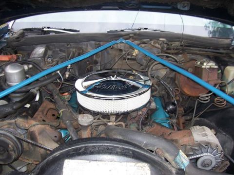 1999 Ford Crown Victoria - Engine bay with aftermarket air cleaner and blue strut tower brace.