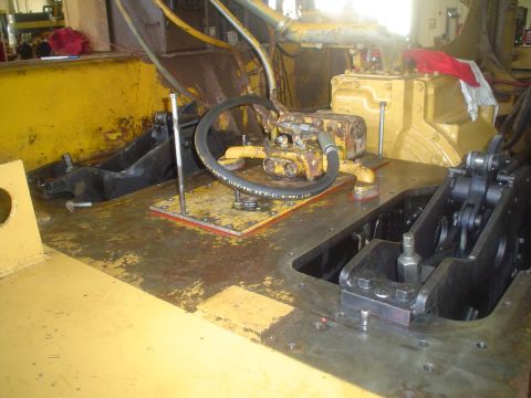 1966 International School Bus - This photo shows the internal workings of heavy machinery, focusing on hydraulic components and mechanical linkages.