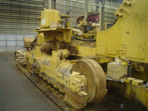 1966 International School Bus - Heavy yellow machinery with tracks is shown from the side, with visible text from Supermotors.net.