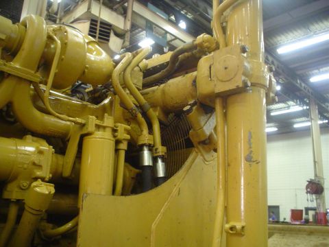 1966 International School Bus - Close-up of a yellow engine, showing complex piping and machinery.