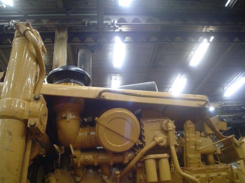 1966 International School Bus - Yellow engine components, likely from heavy machinery, are visible in this close-up shot.