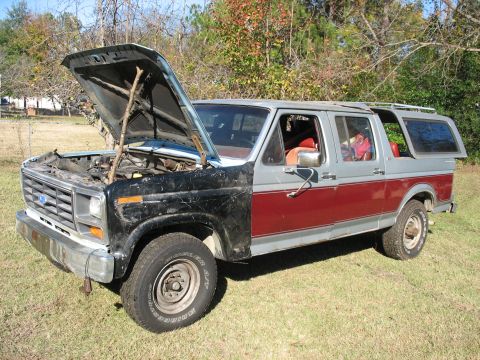 1986 Ford C-350 (Centurion Conversions) - This extended cab pickup truck features a two-tone paint scheme and an open hood, revealing the engine compartment.