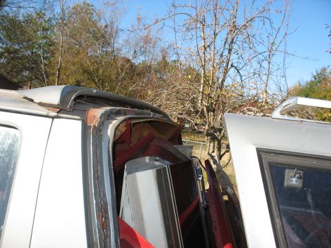 1986 Ford C-350 (Centurion Conversions) - The roof of a vehicle shows significant damage and rust around the edges.