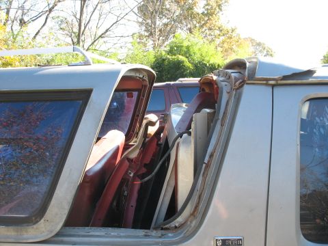 1986 Ford C-350 (Centurion Conversions) - Van interior packed with red parts, with another vehicle in the background.