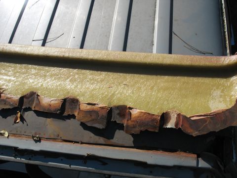 1986 Ford C-350 (Centurion Conversions) - Close-up of damaged and rusted metal with exposed fiberglass material.