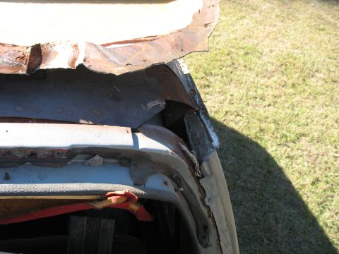 1986 Ford C-350 (Centurion Conversions) - Close-up of heavily rusted and damaged metal on a vehicle's body, indicating significant wear and tear.