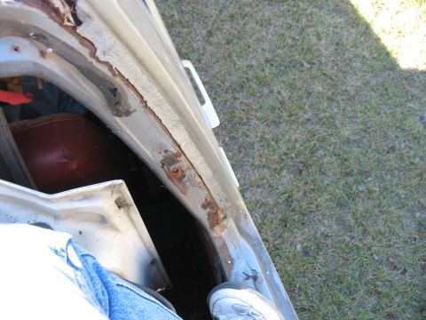 1986 Ford C-350 (Centurion Conversions) - Rusted door frame shows significant wear and tear on the vehicle's body.