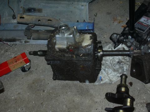1996 Ford Crown Victoria - Transmission and crankshaft parts are laid out on a garage floor, possibly for repair or replacement.