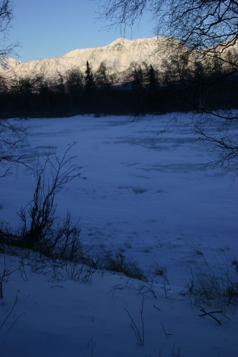 2003 Jeep TJ - A winter scene with snow-covered mountains and a frozen body of water.