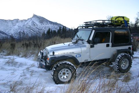 2003 Jeep TJ - A silver 2003 Jeep Wrangler Rubicon is parked in a snowy landscape with a mountain in the background.
