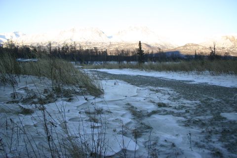 2003 Jeep TJ - Winter scene with snow-covered mountains and dry grass in the foreground.