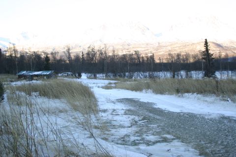 2003 Jeep TJ - Two white vehicles are visible in a snowy rural setting with a cabin and mountains in the background.