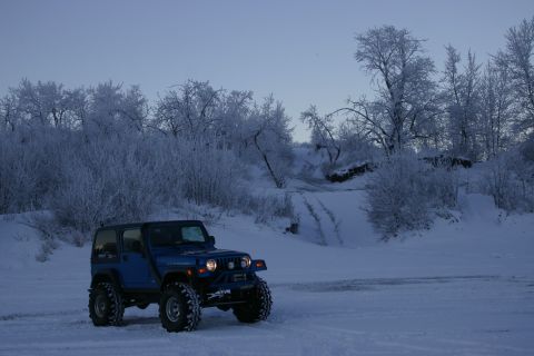 2003 Jeep TJ - Blue 2003 Jeep TJ in a snowy landscape with frosted trees.