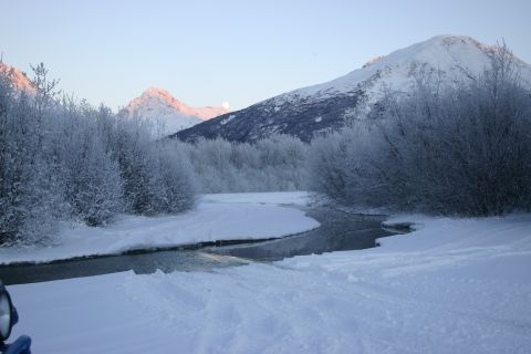 2003 Jeep TJ - A winter scene with snow-covered mountains, a winding river, and frosted trees under a pale sky.