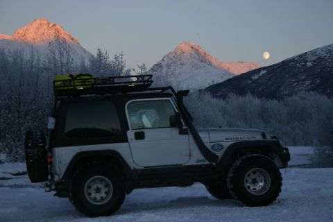 2003 Jeep TJ - A silver 2003 Jeep Wrangler Rubicon is parked in the snow with a scenic mountain backdrop and a full moon overhead.