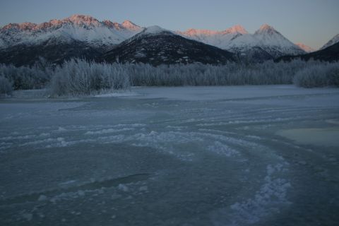 2003 Jeep TJ - A winter scene unfolds with snow-capped mountains in the distance and frosted trees in the foreground.