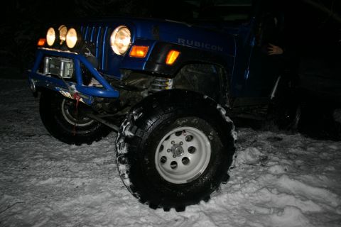 2003 Jeep TJ - Blue 2003 Jeep TJ Rubicon equipped with an aftermarket bumper and winch, parked in the snow.