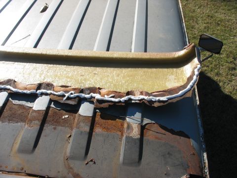 1986 Ford C-350 (Centurion Conversions) - Seam sealant applied to a heavily rusted roof section, indicating repair work.