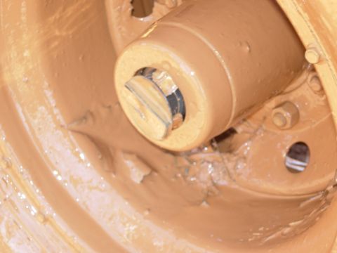 1995 Ford Bronco - Close-up of a mud-covered wheel hub, obscuring any vehicle details.