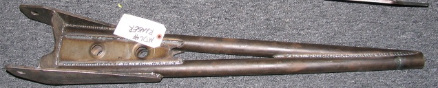 Bare-steel fabricated radius arm with handwritten Ranger tag lying on a gray floor