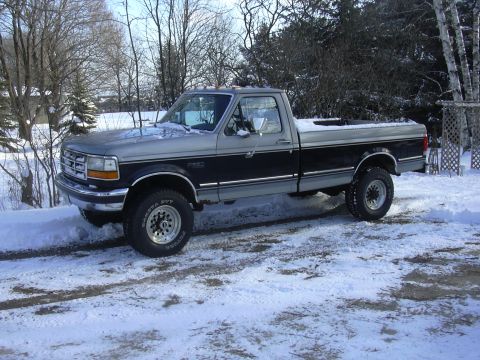 1996 Ford Crown Victoria - This two-tone Ford F-250 pickup truck is parked in a snowy outdoor setting.