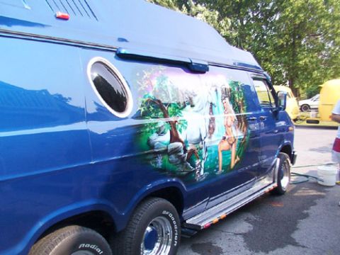 1978 Ford Mustang II - A custom van features a mural on its side, with dual rear wheels visible. Another van is parked nearby.