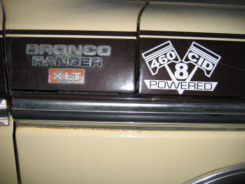 1992 Ford Mustang - Close-up of a vehicle's side panel displaying 'BRONCO RANGER XLT' and '460 8 CID POWERED' decals.