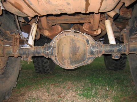 1992 Ford Mustang - Underside view of a vehicle's rear axle, differential, leaf springs, and shock absorbers.