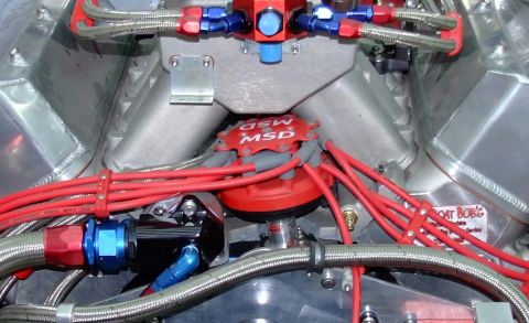 1990 Ford Mustang - Close-up view of performance engine parts including a distributor and spark plug wires.