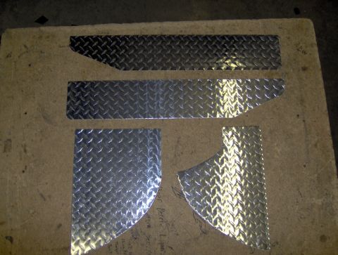 1978 Ford Bronco - Diamond plate metal pieces are shown laid out on a concrete surface, possibly for a vehicle modification project.