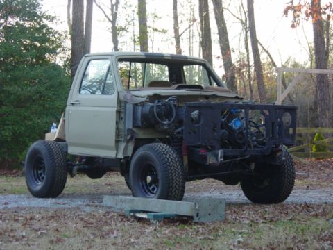 1991 Ford Bronco - This disassembled Ford truck, likely from the 1980s, is undergoing chassis reassembly.