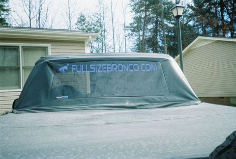 1993 Ford Bronco - The rear window of a vehicle displays a decal for FULLSIZEBRONCO.COM.