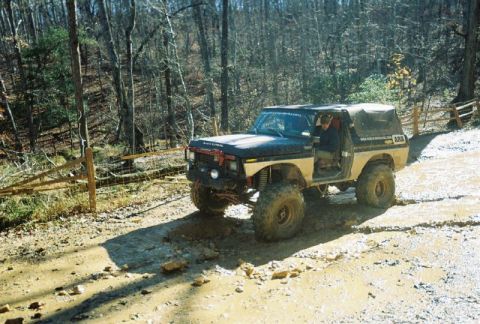 1993 Ford Bronco - This modified 1978 Ford Bronco navigates a muddy, wooded trail with its doors open.