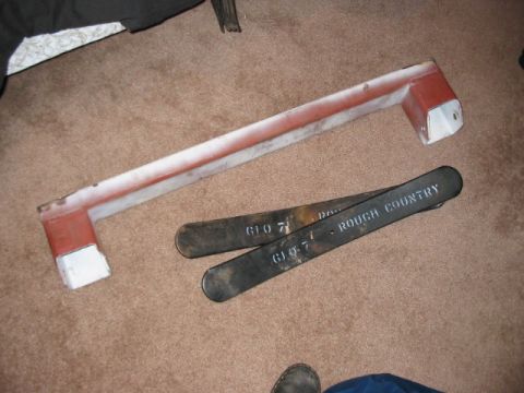 1991 Ford Bronco - Two suspension components, one labeled "ROUGH COUNTRY", are shown on a carpeted floor.