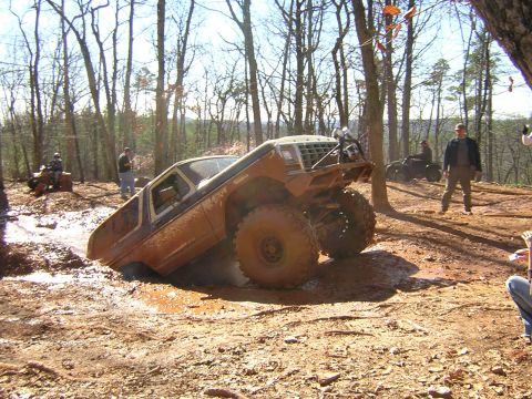 1979 Ford Bronco - A 1979 Ford Bronco navigates a muddy off-road course during a holiday gathering.