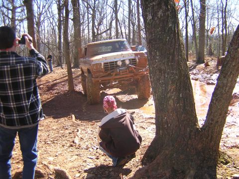 1979 Ford Bronco - A 1979 Ford Bronco navigates a challenging muddy off-road course during an event.