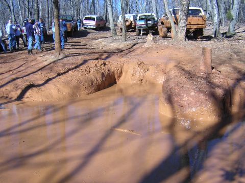 1979 Ford Bronco - Off-road vehicles gathered at a muddy obstacle course during an event.