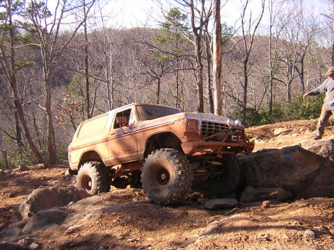 1979 Ford Bronco - A lifted 1979 Ford Bronco navigates a challenging rocky trail during an off-road event.